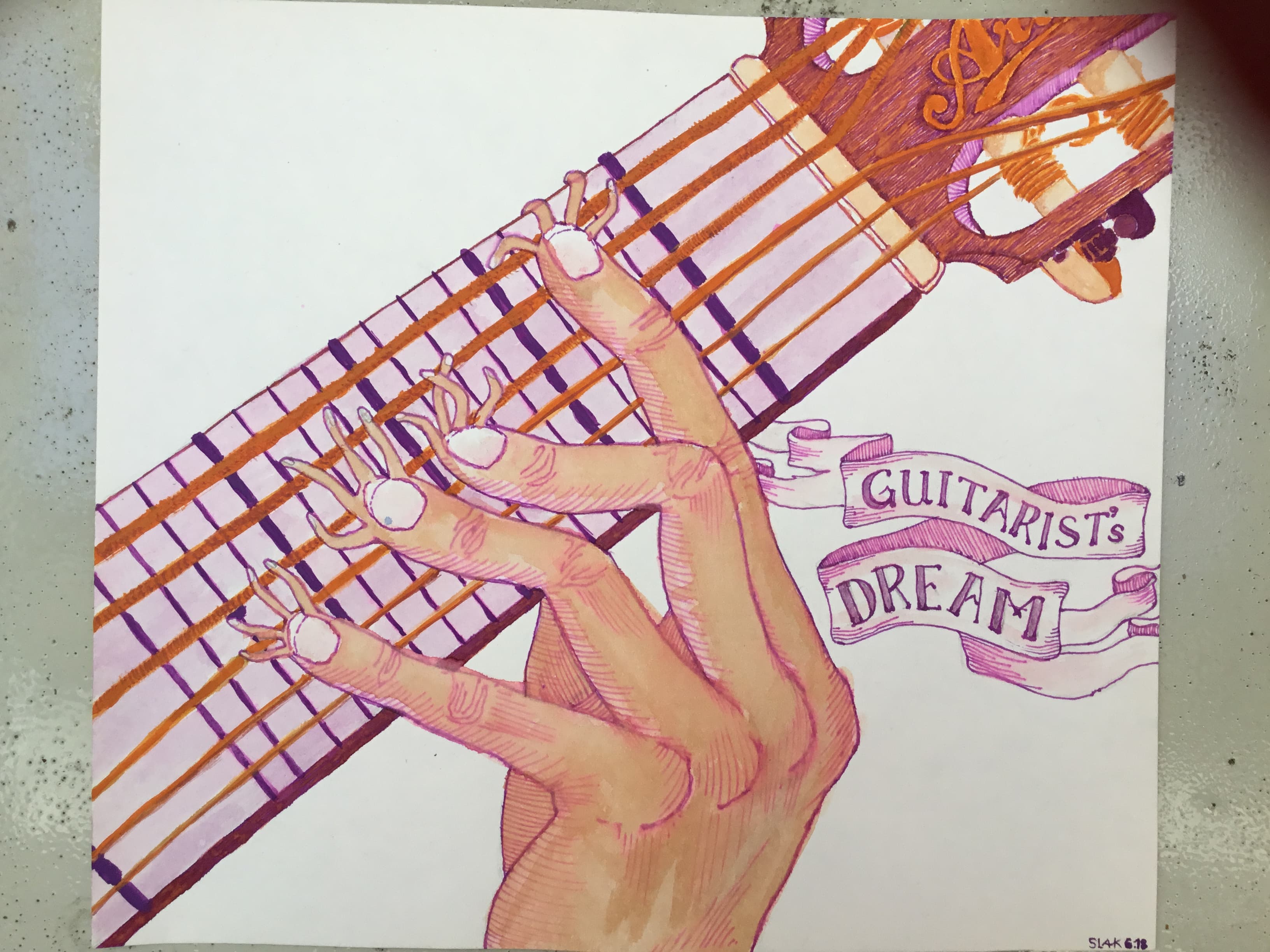 an ink drawing of a hand pressing the strings on a guitar’s neck, beside a banner reading “guitarist’s dream”.